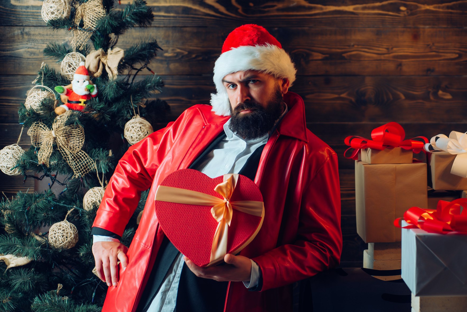 Moderne julenisse med skjegg og hjerteforma julepakke