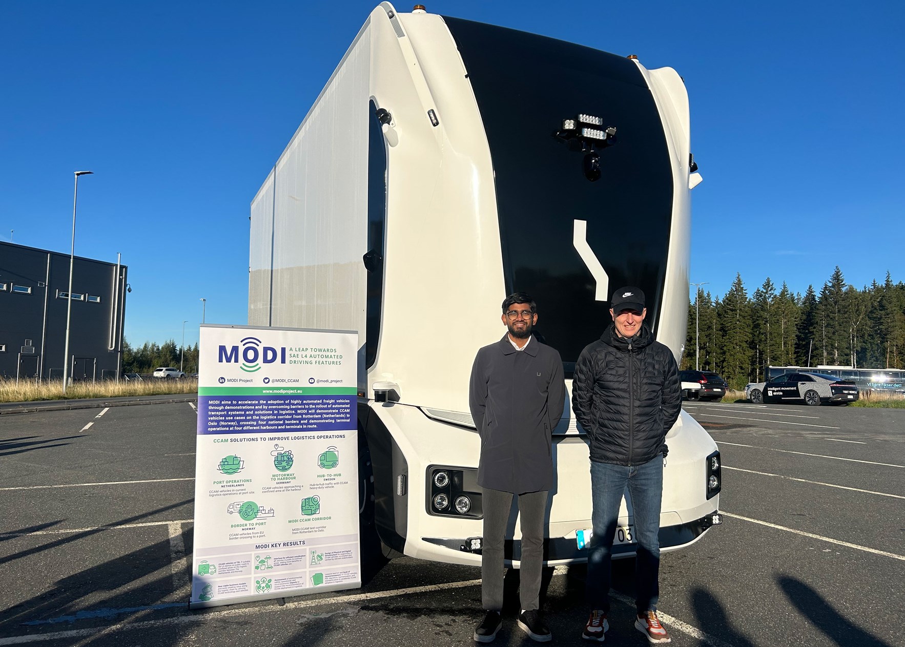 To personer p&aring; grenseovergangen ved &Oslash;rje foran en f&oslash;rerl&oslash;s trailer fra Einride